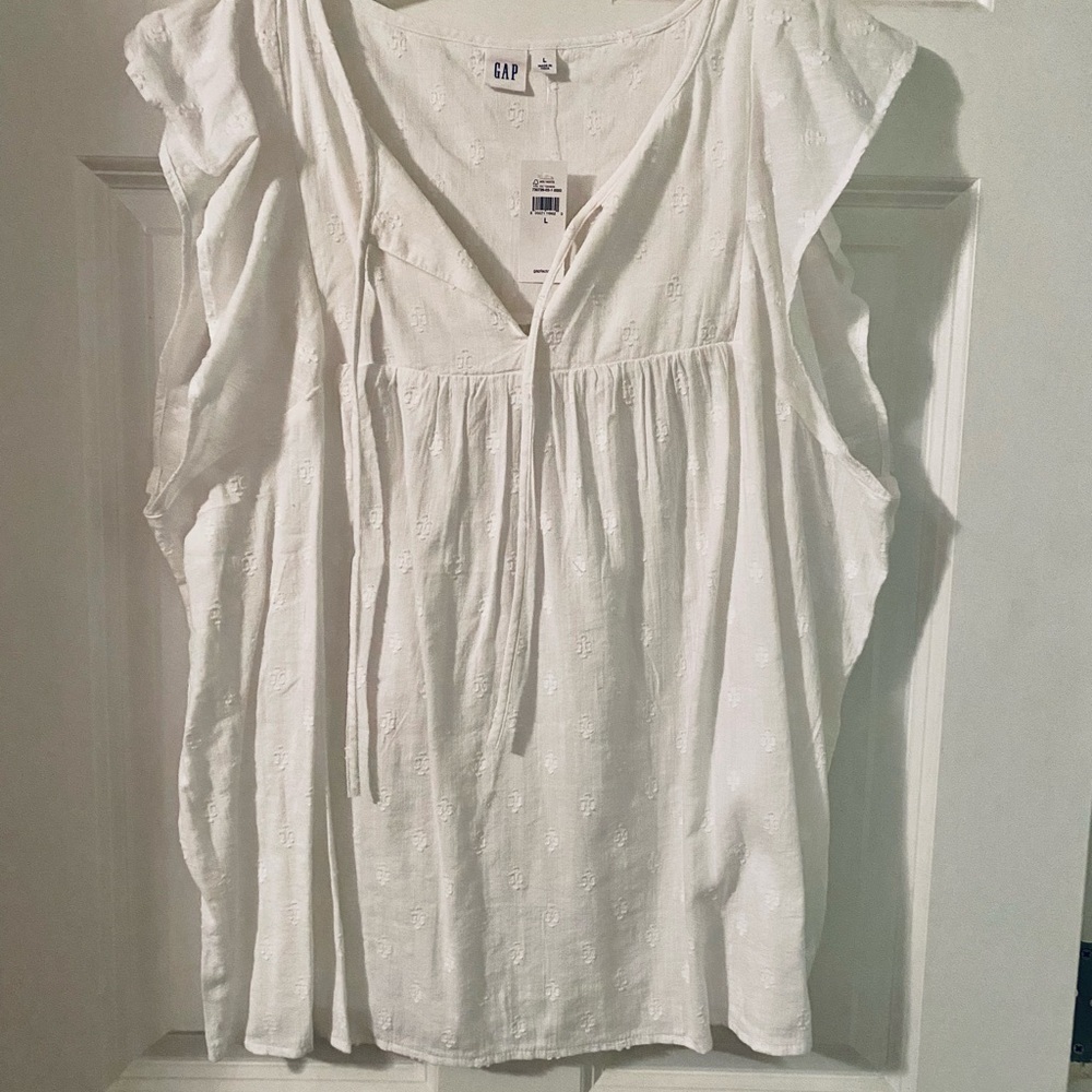 White sleeveless blouse with embroidered print